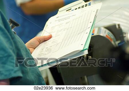 Stock Photograph - Surgeon holding hospital chart.. Fotosearch