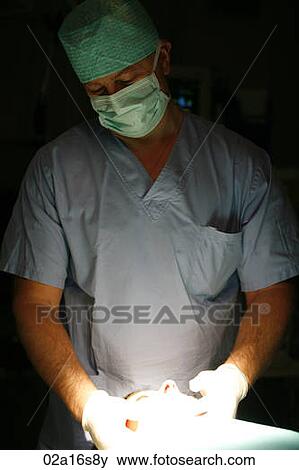 Surgeon holding patients head View Large Photo Image Stock Photo - Surgeon holding patients head. Fotosearch