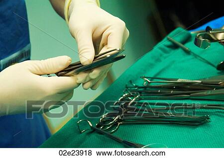Surgeon selecting sterilized tool for operation. View Large Photo Image Stock Photo - Surgeon selecting sterilized tool for operation.. Fotosearch
