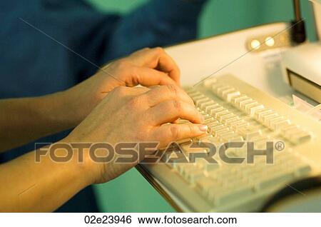 Surgical nurse typing report on computer in OR. View Large Photo Image Stock Photograph - Surgical nurse typing report on computer in OR.. Fotosearch