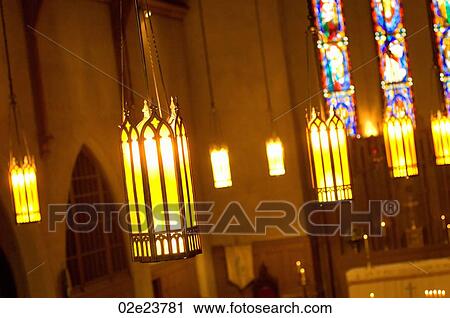 Stock Image - Suspended lights inside church.. Fotosearch