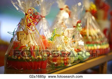 Stock Photography - Sweets wrapped and tied with colourful ribbons. Fotosearch