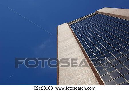 Stock Photo - Tall office building with blue sky background.. Fotosearch