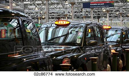 Taxi cabs waiting at Edinburgh train station, UK. View Large Photo Image Picture - Taxi cabs waiting at Edinburgh train station, UK.. Fotosearch