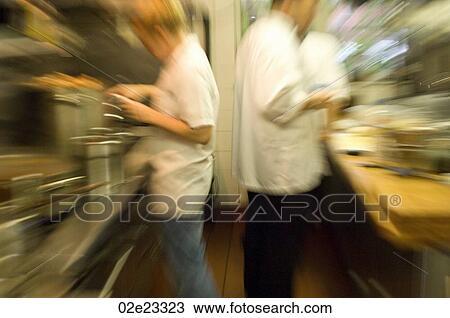 Team of busy cooks in restaurant kitchen. View Large Photo Image Stock Image - Team of busy cooks in restaurant kitchen.. Fotosearch