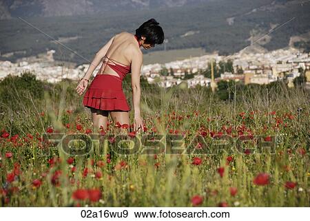 Stock Photo - Teenage girl in field of wildflowers, Granada, Andalusia. Fotosearch