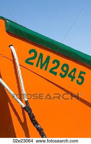 Tight close-up of orange and green fishing dory. View Large Photo Image Picture - Tight close-up of orange and green fishing dory.. Fotosearch