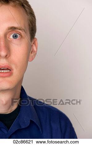 Tight crop of half a face of a scared man. View Large Photo Image Stock Image - Tight crop of half a face of a scared man.. Fotosearch