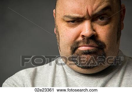 Stock Image - Tight crop of serious man's face.. Fotosearch