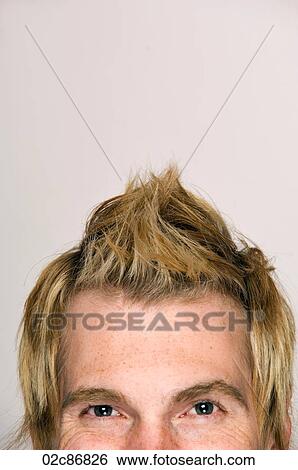 Stock Photograph - Tight crop of young male with interesting hairstyle.. Fotosearch