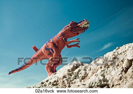 Toy Dinosaur on rocks View Large Photo Image Stock Image - Toy Dinosaur on rocks. Fotosearch
