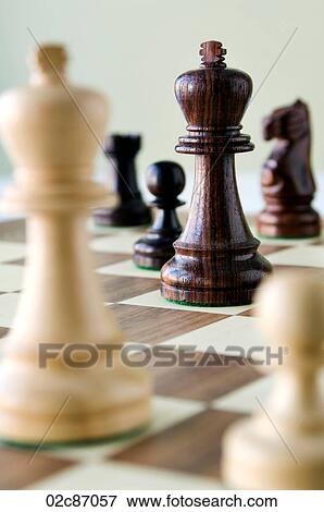 Traditional wooded chess game pieces on playing board. View Large Photo Image Stock Photo - Traditional wooded chess game pieces on playing board.. Fotosearch