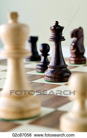 Traditional wooded chess game pieces on playing board. View Large Photo Image Stock Photo - Traditional wooded chess game pieces on playing board.. Fotosearch