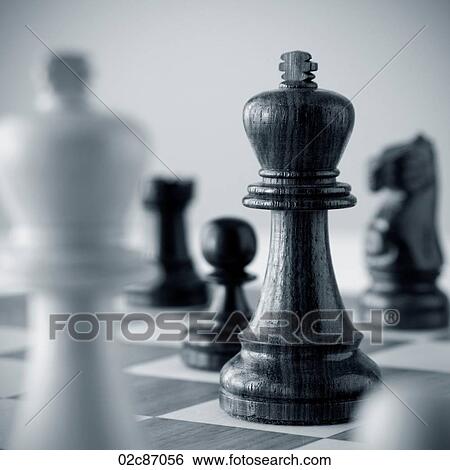 Stock Photograph - Traditional wooded chess game pieces on playing board.. Fotosearch