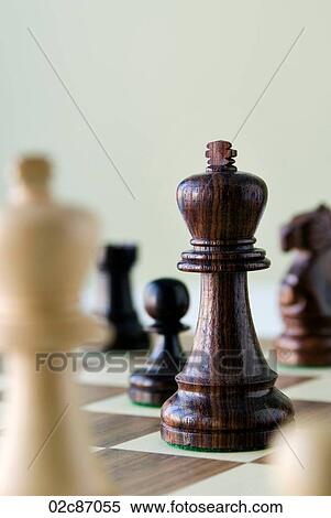 Traditional wooded chess game pieces on playing board. View Large Photo Image Stock Photography - Traditional wooded chess game pieces on playing board.. Fotosearch
