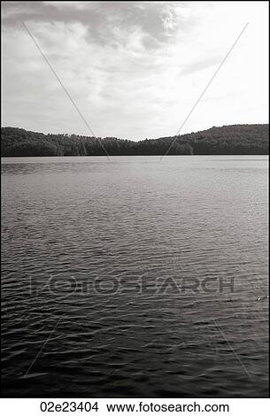 Tranquil view of ripples on peaceful lake. View Large Photo Image Picture - Tranquil view of ripples on peaceful lake.. Fotosearch