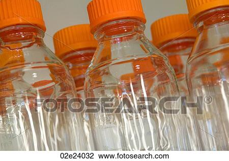 Stock Image - Transparent glass bottles in research laboratory.. Fotosearch