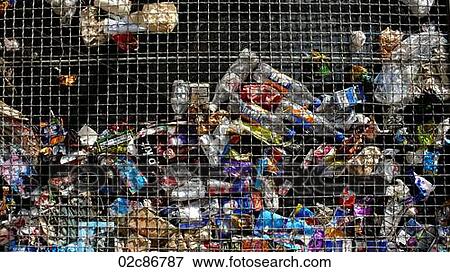Stock Photo - Trash behind metal grating.. Fotosearch