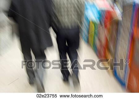 Two blurring people walking. View Large Photo Image Stock Photography - Two blurring people walking.. Fotosearch
