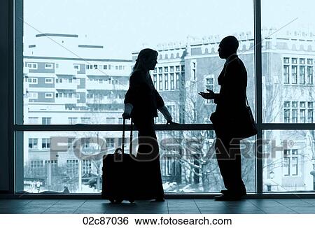 Two business colleagues silhouetted in a large window. View Large Photo Image Stock Photograph - Two business colleagues silhouetted in a large window.. Fotosearch