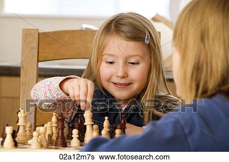 Stock Photograph - Two girls playing chess. Fotosearch