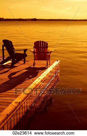 Two Muskoka chairs on dock. View Large Photo Image Picture - Two Muskoka chairs on dock.. Fotosearch