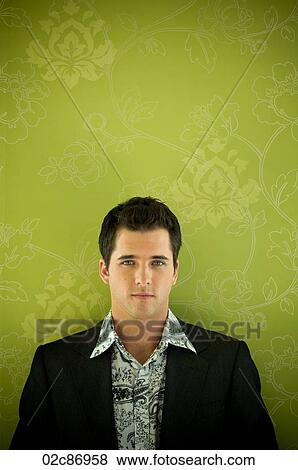 Stock Photo - Urban business man against floral wallpaper.. Fotosearch