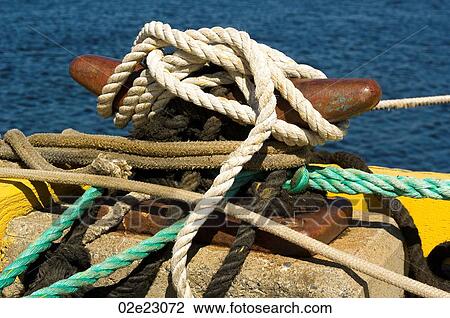 Variety of ropes tied to cleat on fishing pier. View Large Photo Image Stock Image - Variety of ropes tied to cleat on fishing pier.. Fotosearch