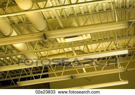 Stock Image - View of lighting and ceiling vents of a high ceiling.. Fotosearch
