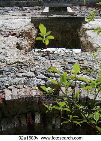 Stock Photo - View up the wall of an old castle, with a tree branch. Fotosearch