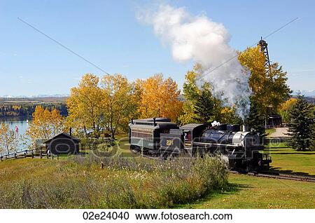 Vintage steam engine traveling through Heritage Park in Calgary Canada. View Large Photo Image Stock Image - Vintage steam engine traveling through Heritage Park in Calgary Canada.. Fotosearch