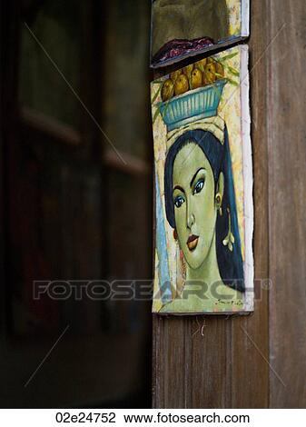 Stock Image - Wall plaque of Asian woman in Bali. Fotosearch