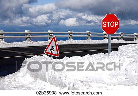 Warning road signs on snow covered road View Large Photo Image Stock Photo - Warning road signs on snow covered road. Fotosearch