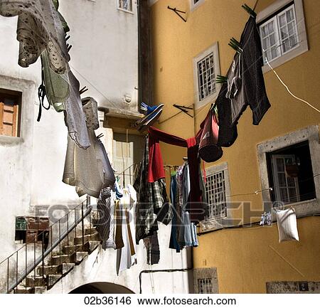 Stock Photograph - Washing hangs in courtyard, Lisbon, Portugal. Fotosearch