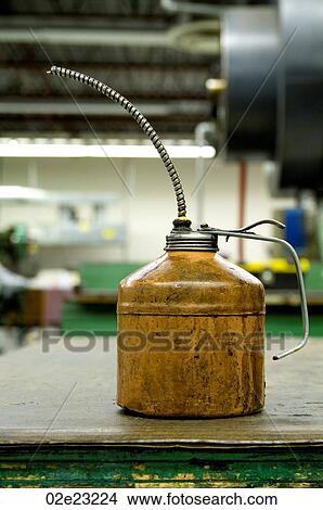 Well used oil can in factory. View Large Photo Image Picture - Well used oil can in factory.. Fotosearch