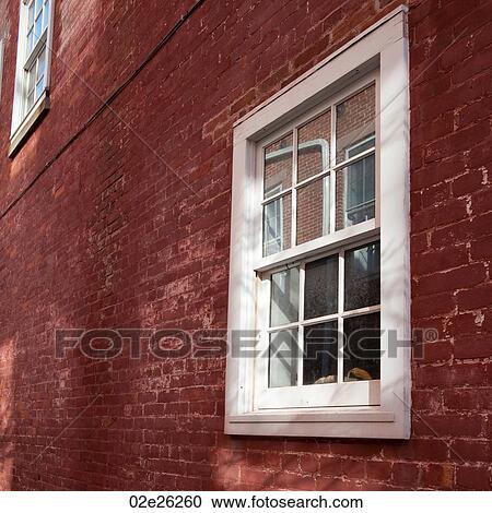 Stock Image - Windows and brick exterior of a building in the Hamptons. Fotosearch