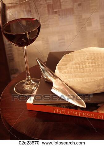Stock Image - Wine and cheese on a side table.. Fotosearch