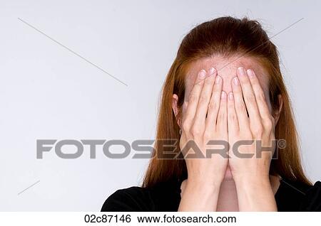 Stock Photograph - Woman covering face with hands.. Fotosearch