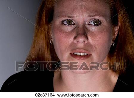 Woman looking frightened. View Large Photo Image Picture - Woman looking frightened.. Fotosearch