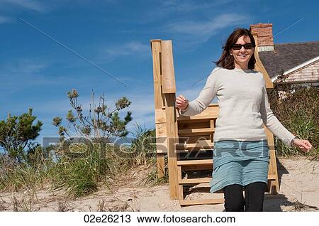 Woman on the beach in the Hamptons View Large Photo Image Stock Image - Woman on the beach in the Hamptons. Fotosearch