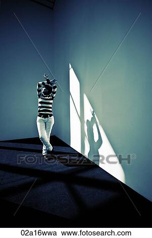 Woman stands with arms and legs crossed in sunlit room, New York View Large Photo Image Stock Image - Woman stands with arms and legs crossed in sunlit room, New York . Fotosearch