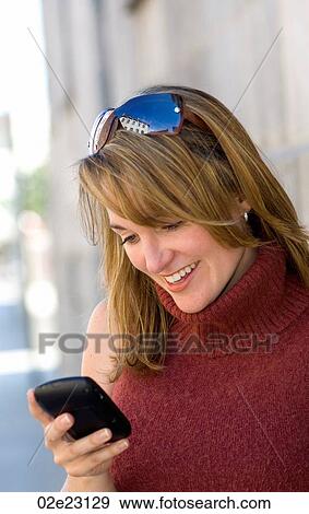 Women reading text on PDA. View Large Photo Image Stock Photo - Women reading text on PDA.. Fotosearch