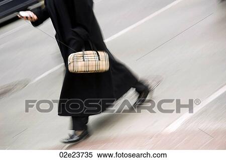 Women walking across sreet while online with PDA. View Large Photo Image Stock Photography - Women walking across sreet while online with PDA.. Fotosearch