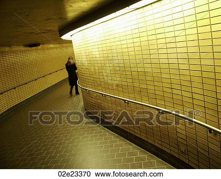 Women walking down underground subway corridor. View Large Photo Image Stock Image - Women walking down underground subway corridor.. Fotosearch