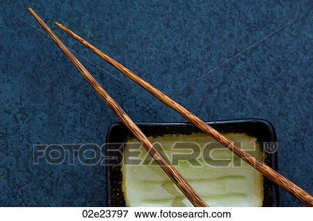 Wooden chopsticks with dish on blue background. View Large Photo Image Stock Photo - Wooden chopsticks with dish on blue background.. Fotosearch