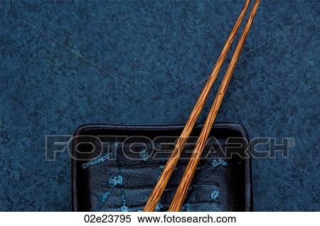 Wooden chopsticks with dish on blue background. View Large Photo Image Stock Photography - Wooden chopsticks with dish on blue background.. Fotosearch