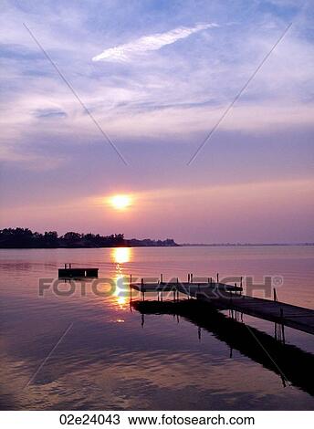 Stock Image - Wooden dock at edge of lake, Sandbanks, Ontario, Canada.. Fotosearch