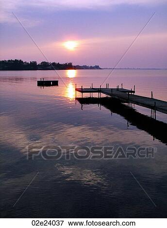 Wooden dock at edge of lake, Sandbanks, Ontario, Canada. View Large Photo Image Stock Photo - Wooden dock at edge of lake, Sandbanks, Ontario, Canada.. Fotosearch