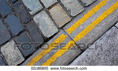 Yellow lines beside cobblestones street. View Large Photo Image Stock Image - Yellow lines beside cobblestones street.. Fotosearch