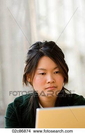 Young Asian university student working on computer laptop. View Large Photo Image Picture - Young Asian university student working on computer laptop.. Fotosearch